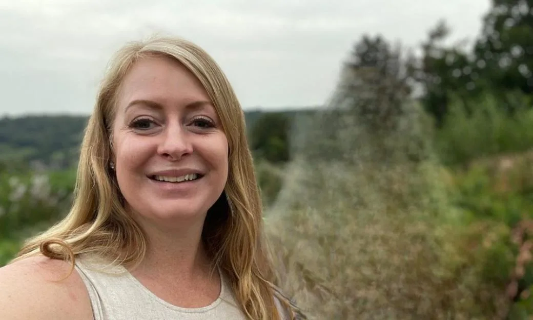 Jennifer smiling in an outdoor setting.