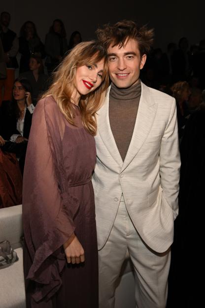 Suki Waterhouse and Robert Pattinson posing together at the Dior Fall 2023 Menswear Show in Giza, Egypt.