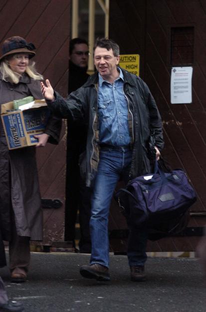 Andy Kershaw, a disc jockey, leaving prison with a woman carrying a box of Frosties.