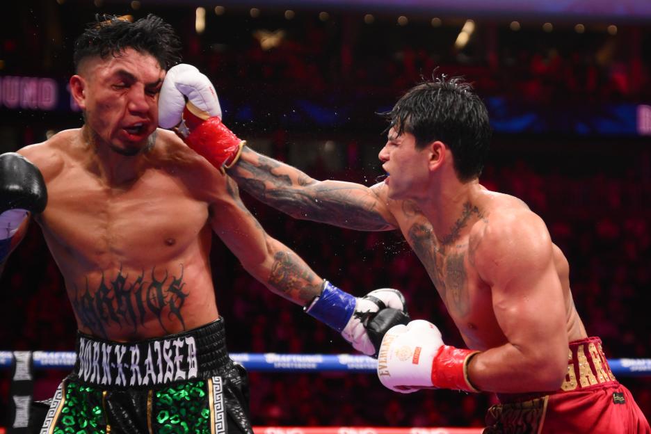Ryan Garcia lands a punch on Mario Barrios's face during their WBC world welterweight title boxing match.