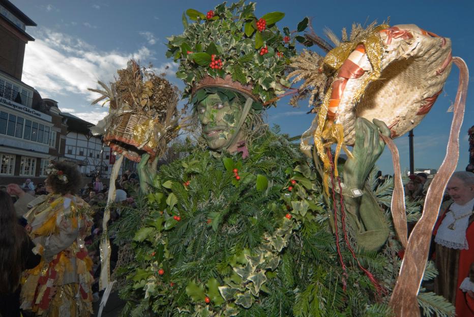 The Holly Man holding up crowns for King Bean and Queen Pea at Bankside Twelfth Night celebrations.