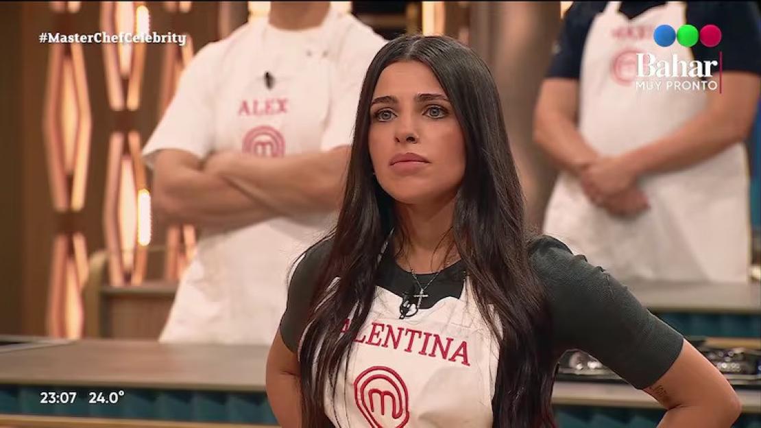 A woman wearing a white apron with "VALENTINA" and the MasterChef logo on it.