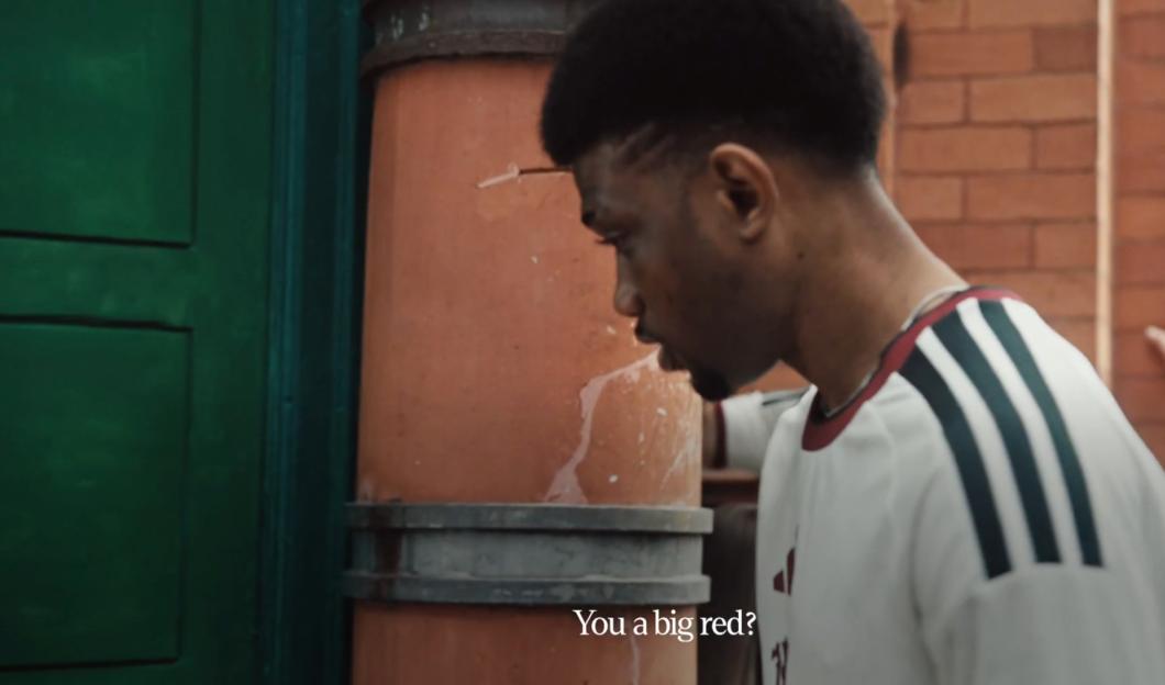 A man in a white and green striped shirt looking down with the caption "You a big red?" on screen.