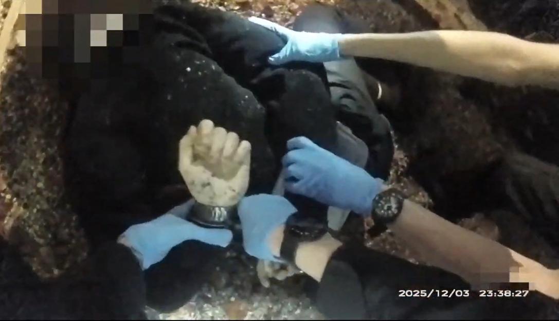 Police in blue gloves handcuffing 18-year-old Henry Nowak.