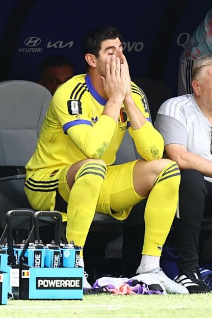 Belgium goalkeeper Thibaut Courtois looking dejected on the bench during the 2026 FIFA World Cup quarter-final match against Spain.