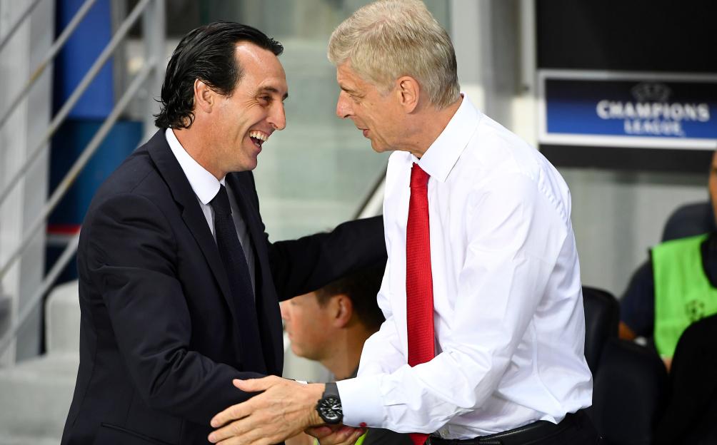 Unai Emery and Arsene Wenger shake hands on a football field.