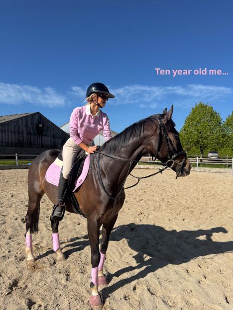 Faye Winter on horseback, dressed in riding gear.