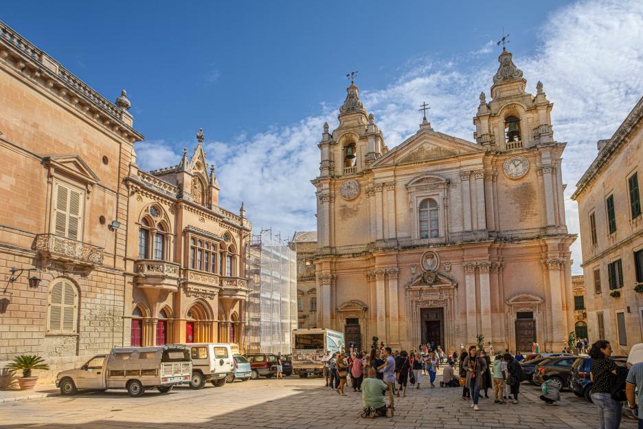 St. Paul's Cathedral in Mdina, Malta, with people gathered in the square.