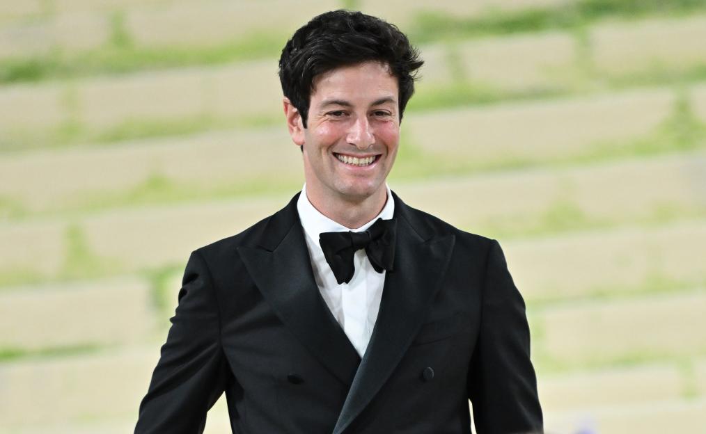 Joshua Kushner smiling in a black tuxedo with a black bow tie and white shirt.