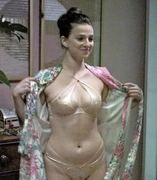 Marisa Abela in a bra and underwear, letting a floral robe slip from her shoulders.