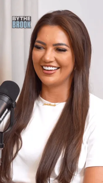 Sophie Kasaei smiling during an interview with a microphone in front of her.