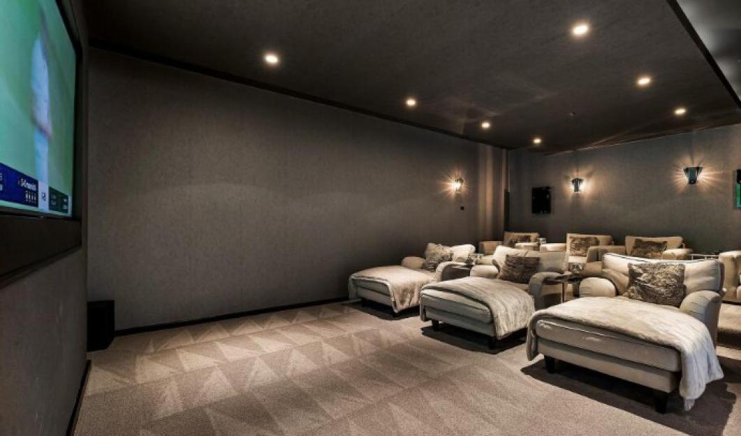 Home cinema room with comfortable recliners.