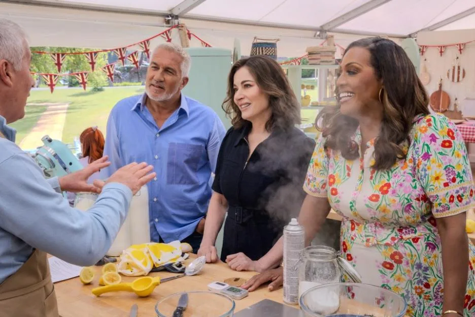 Alison Hammond, Nigella Lawson, and Paul Hollywood from The Great British Bake Off Season 17 gathered around a table with baking ingredients.