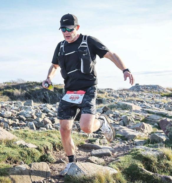 John McAvoy running a trail race.