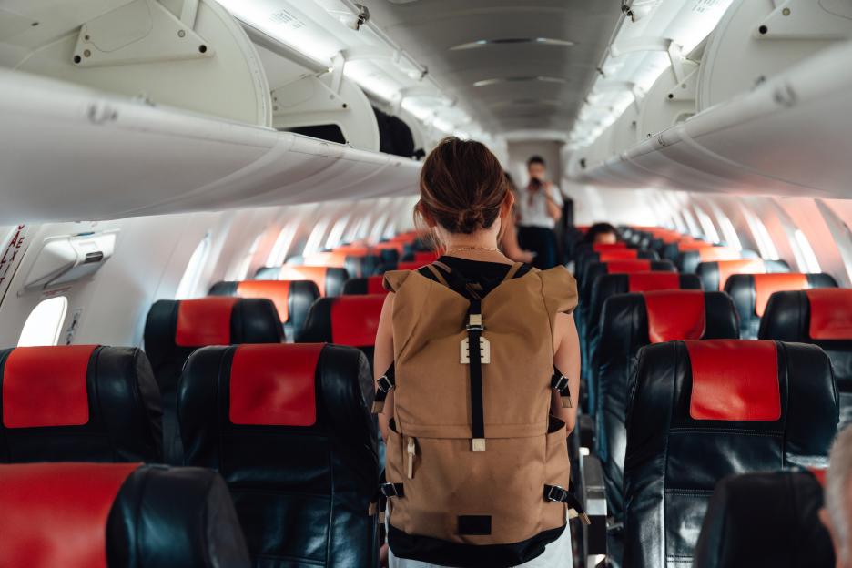 Young Asian woman boarding an airplane.