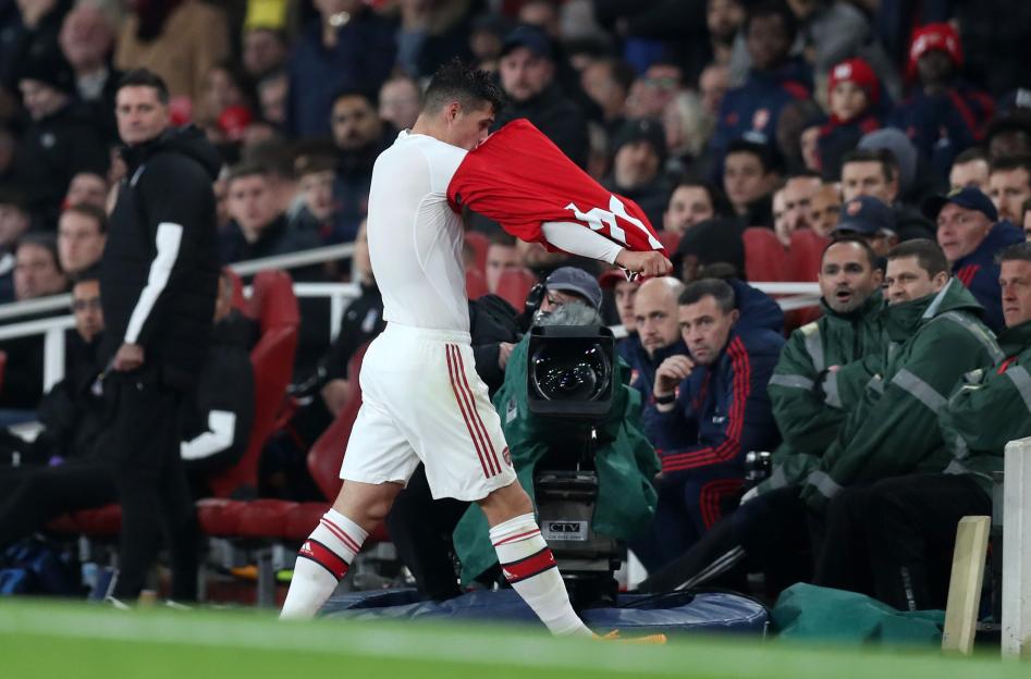 Granit Xhaka of Arsenal removes his jersey as he leaves the pitch after being substituted.