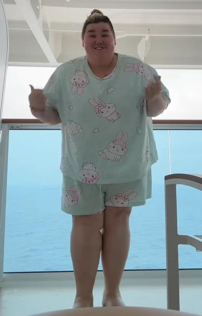 Becki Jones wearing green pajamas with bunny patterns on a cruise ship.