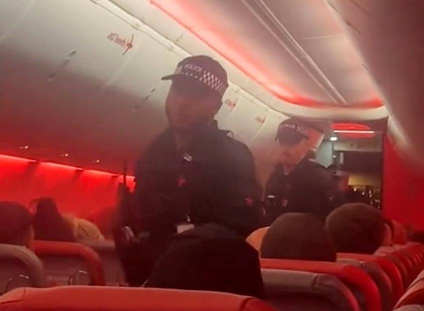 Police officers boarding a Jet2 flight at Manchester airport.