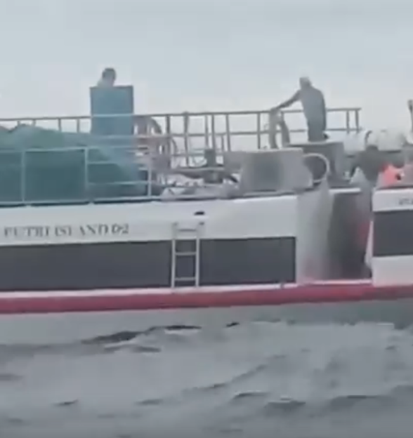 A boat named "Putri Island 02" with people on deck.