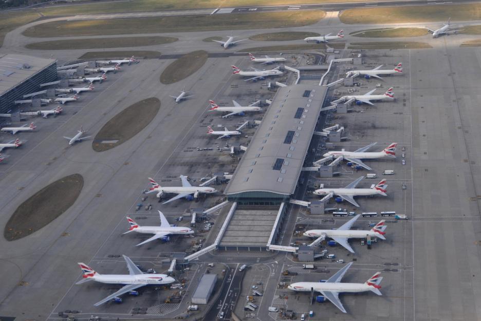 Aerial view of numerous planes parked at Heathrow Terminal 5.