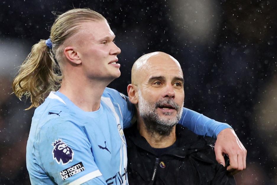 Manchester City manager Pep Guardiola celebrates with Erling Haaland after a match.