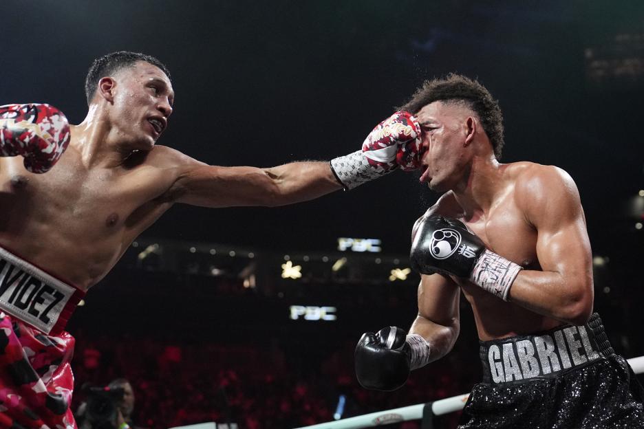 David Benavidez lands a left punch to David Morrell during a light heavyweight title boxing match.
