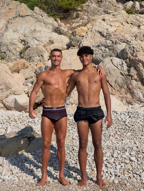 Cristiano Ronaldo and son Cristiano Ronaldo Jr. pose together on a rocky beach in Mallorca.