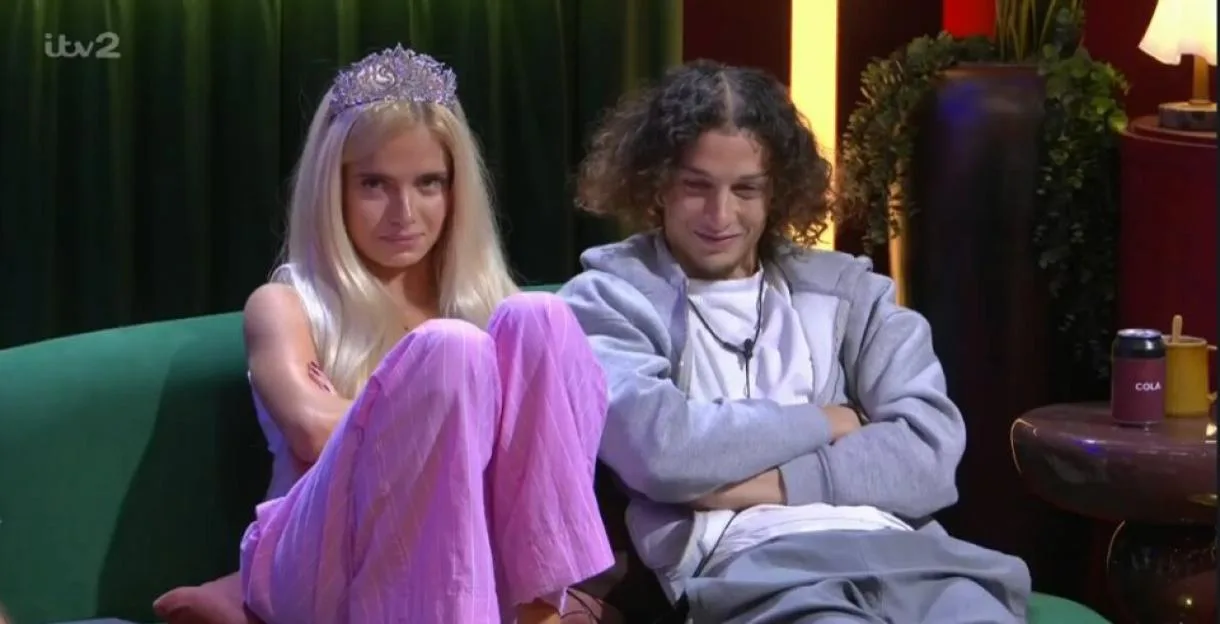 Rhianna wearing a tiara and Rob sitting next to her on a sofa.