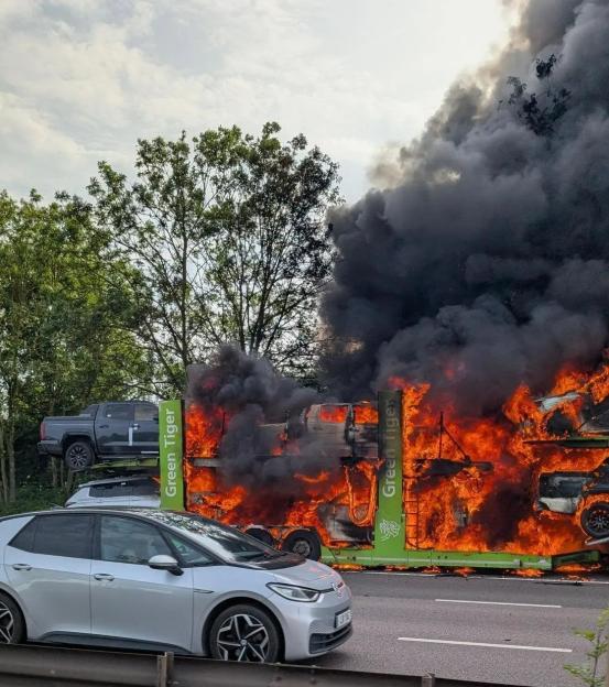 Fiery Catastrophe: Car Transporter Engulfed in Flames, Disrupting Major Motorway with Burning Vehicles