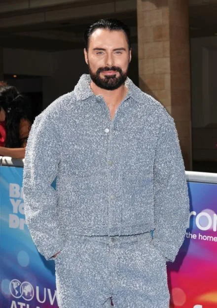 Rylan Clark posing at the TRIC Awards 2025.