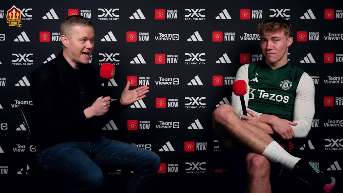 Rasmus Højlund being interviewed by Goldbridge for The United Stand, with Manchester United branding and sponsor logos in the background.
