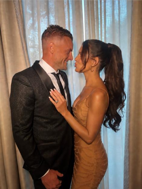 Rebekah Vardy in a gold dress with husband Jamie Vardy in a suit.