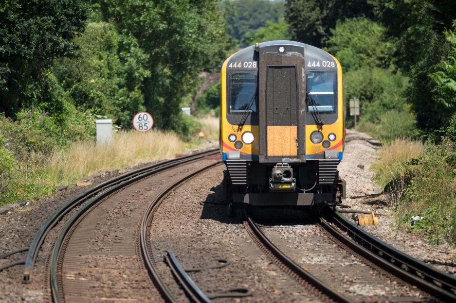 Delayed due to speed limits in hot weather, South Western railway 444 Class commuter train southbound between London Waterloo and Portsmouth