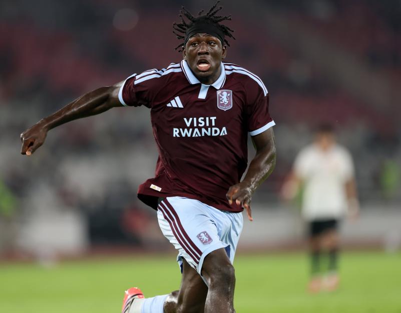 Aston Villa player in maroon and blue uniform running on a green field.
