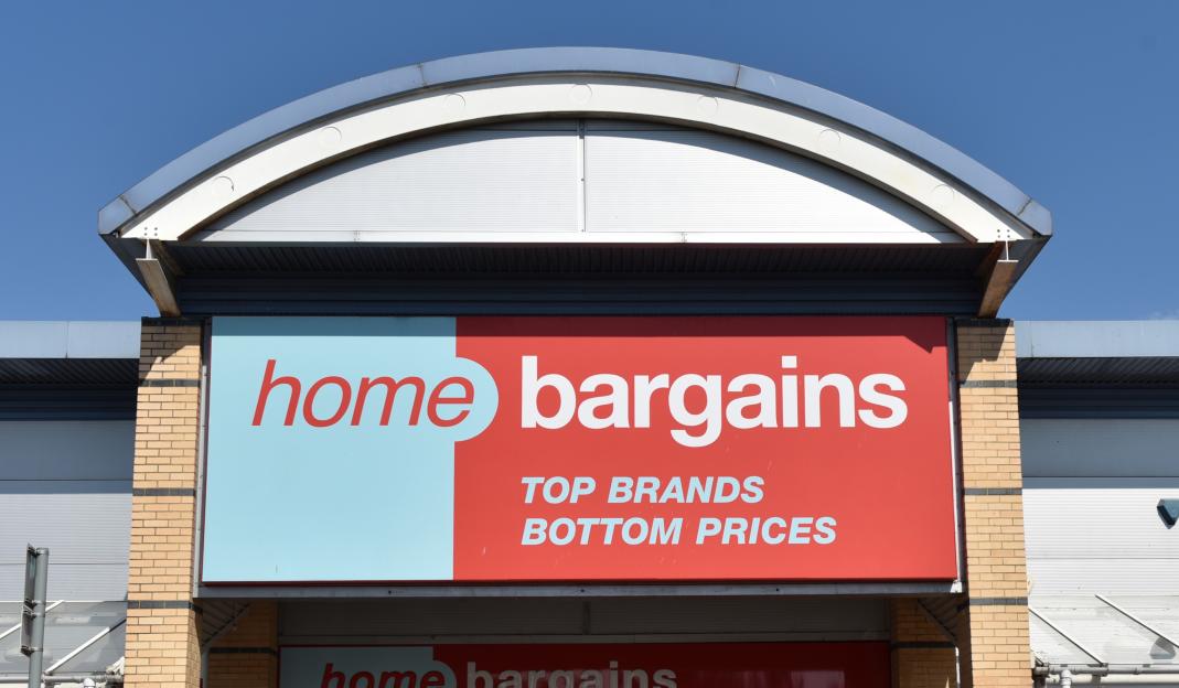 A Home Bargains discount retail outlet store with "TOP BRANDS BOTTOM PRICES" on its sign.