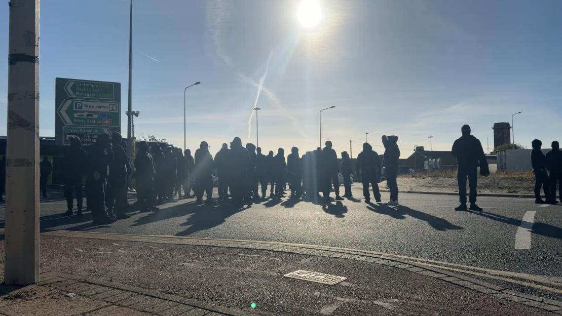 A group of protestors blocking a road in Dover, England.
