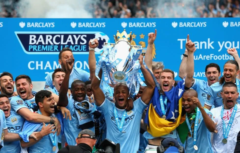 Vincent Kompany of Manchester City lifts the Premier League trophy.