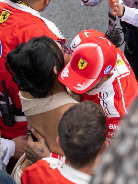 Lewis Hamilton in a red Ferrari cap and Kim Kardashian with purple sunglasses at the F1 Grand Prix of Monaco.