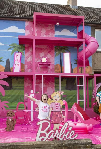 Five year-old Ayda enjoys her Barbie Dreamhouse. / A mum has spent £5,000 transforming her home into a 'Barbie Dreamhouse' - complete with pink slide. Nicole Watt, 27, has decorated the outside of...