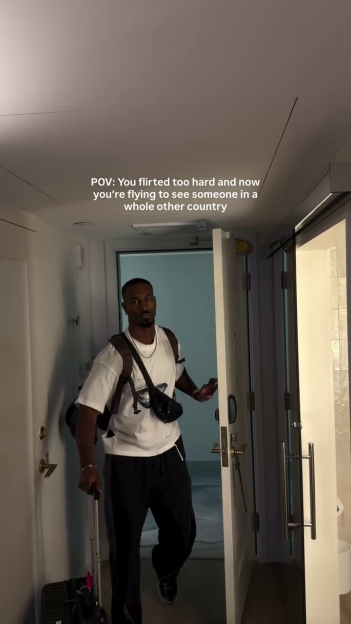 Yamen from Love Island entering a room with his luggage.