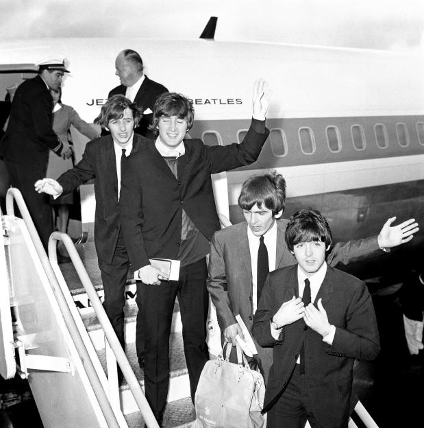 The Beatles boarding a plane at Heathrow airport in 1964.