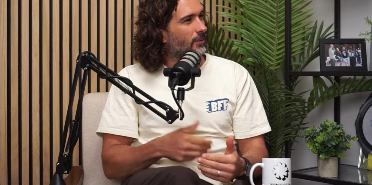 Joe Wicks being interviewed, gesturing with his hands.