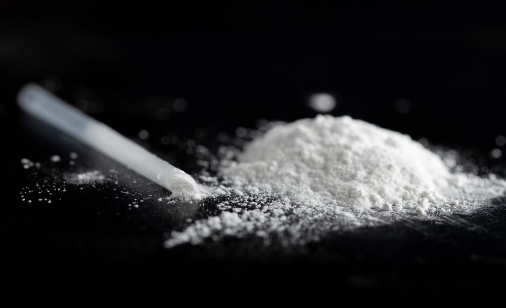 Ketamine powder and a plastic straw.