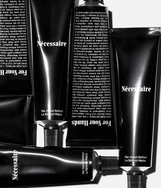 A collage of Necessaire "The Hand Retinol" tubes with text in English and French.