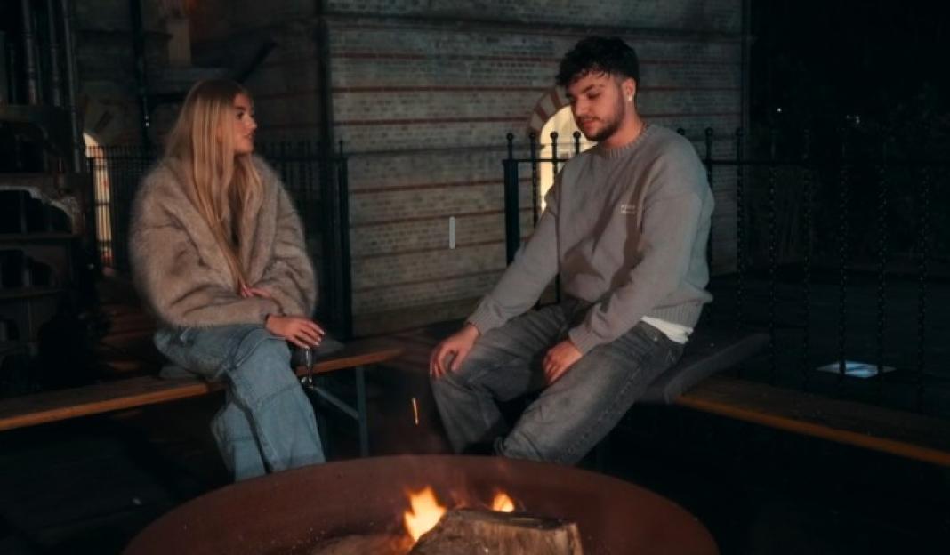Princess and Junior Andre sitting next to a fire pit.