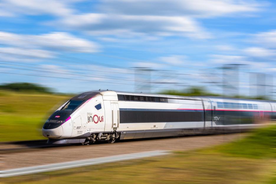 A TGV Euroduplex inOui high-speed train traveling through the countryside.