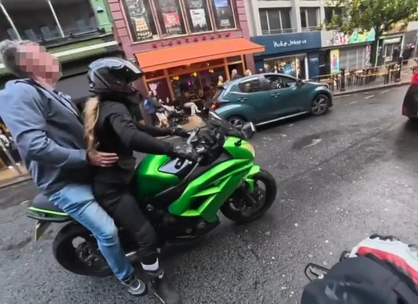 Shock moment ‘inappropriate old man’ leaps on female rider’s motorbike & grabs her waist before she slaps him on ear