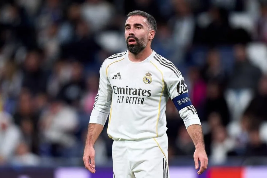Real Madrid player Dani Carvajal wearing the team's white home kit and captain's armband during a match against AS Monaco.