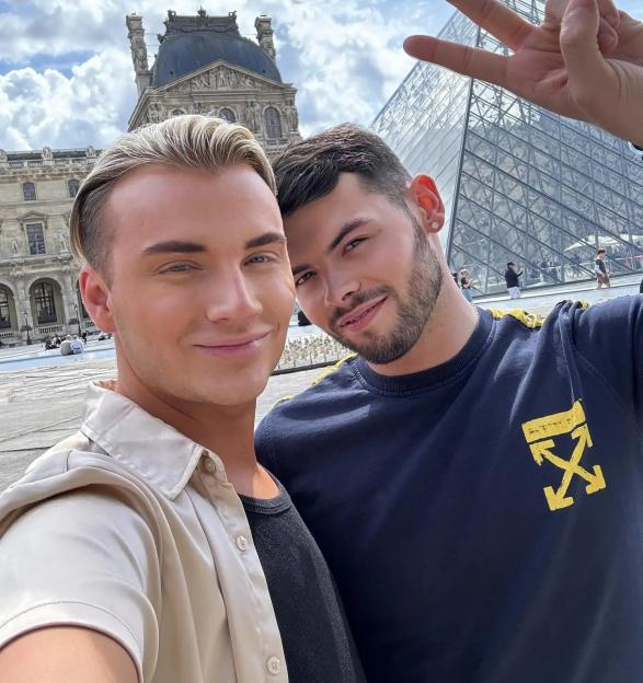 two men posing for a picture with one wearing a shirt that says " off white "