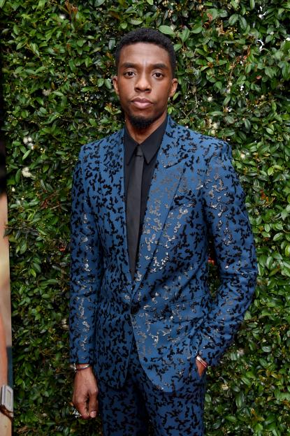 Chadwick Boseman in a blue patterned suit on the red carpet.